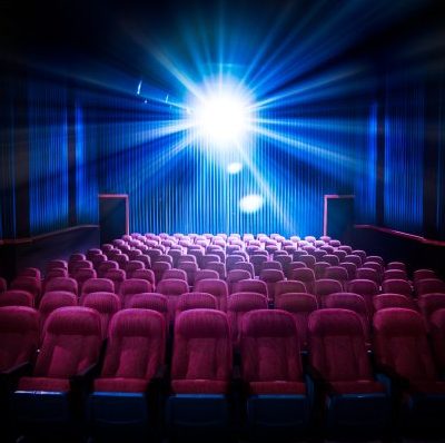 Movie,Theater,With,Empty,Seats,And,Projector,/,High,Contrast